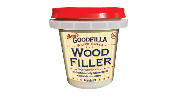 A container of Goodfilla Wood Filler with a red lid.