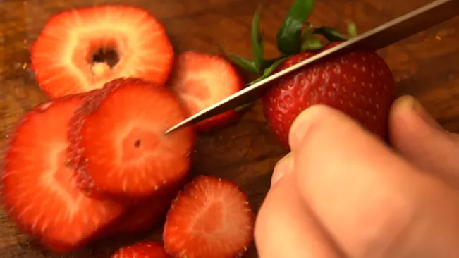 Cutting strawberries on board