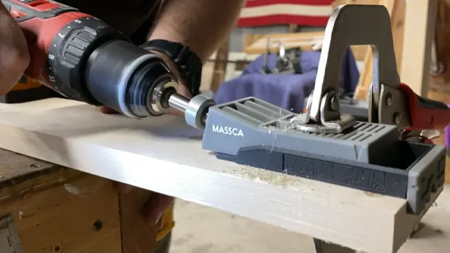 Person using a drill on wood clamped in a Massca pocket hole jig