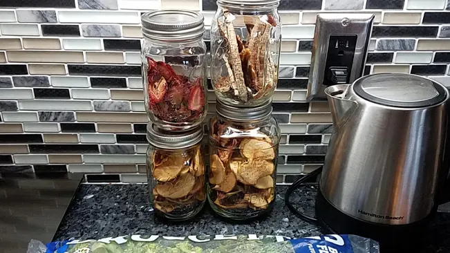 Dried fruit in jars and kettle