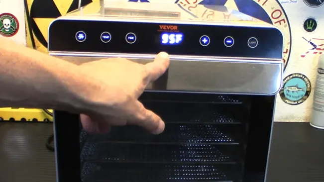 Person setting the temperature on a VEVOR oven to 95°F.