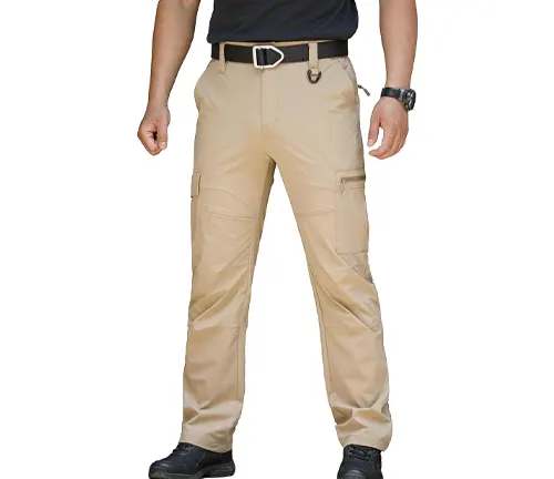 A person wearing light beige tactical pants featuring multiple cargo pockets and a black belt, paired with dark shoes, standing in a neutral stance.