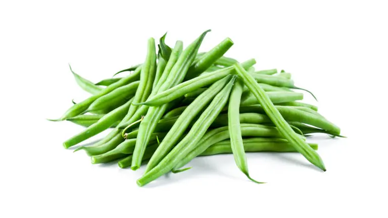 A pile of fresh green string beans displayed on a white background.