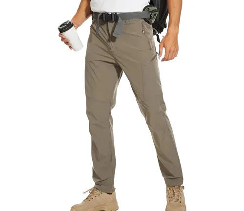 A person standing in a casual pose wearing light gray hiking pants and tan hiking boots, holding a coffee cup, with a black belt equipped with a small pouch.