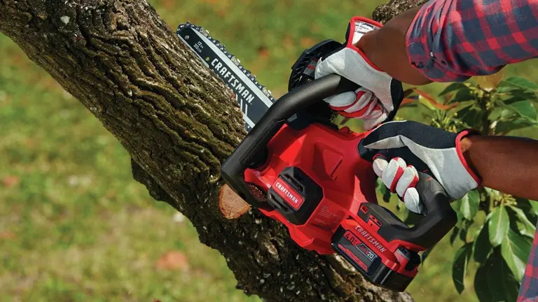 Person using Craftsman 20V Chainsaw cutting tree
