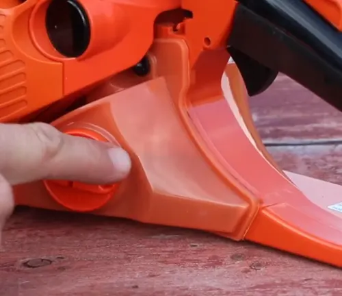 Person pointing the translucent  gas tank of captive bar nuts