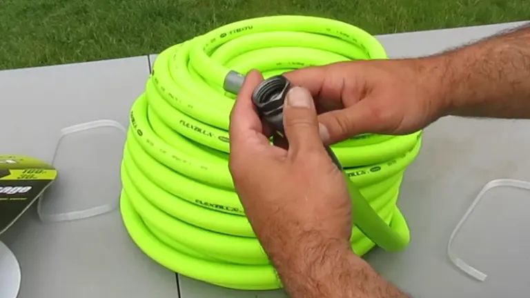 Person holding a disconnected end of a Flexzilla garden hose, showing the fitting details.