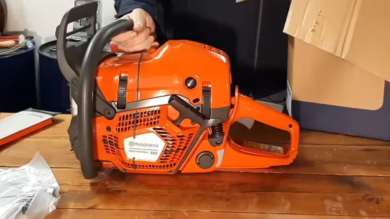 Person unboxing the Husqvarna 585 