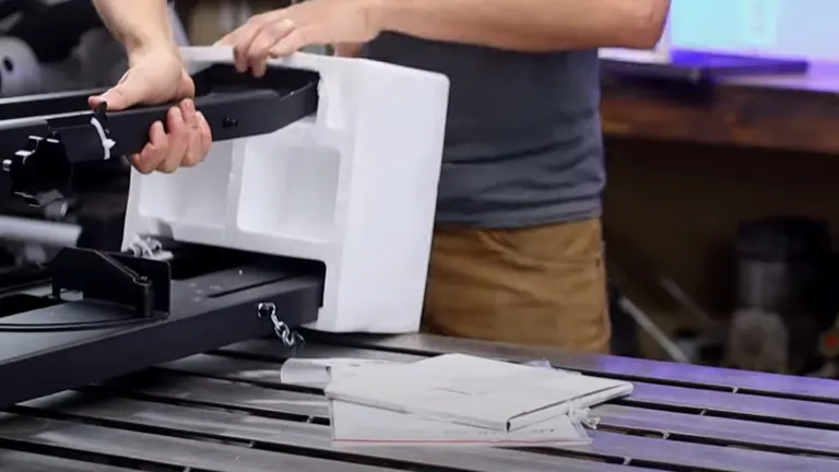 Person unboxing the Hercules Universal Portable Band Saw Benchtop Stand