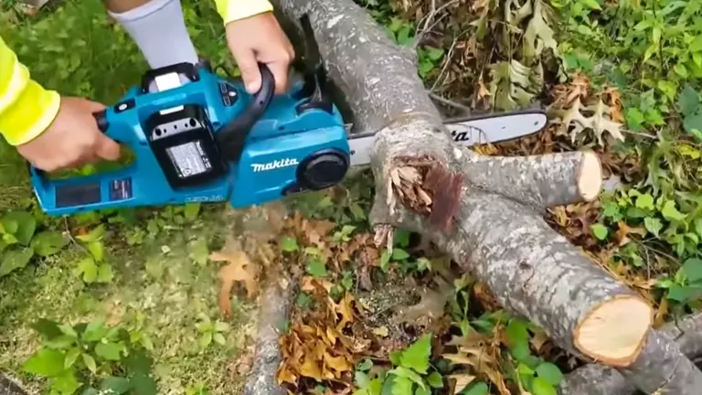 Person using Makita XCU03PT Chainsaw cutting log
