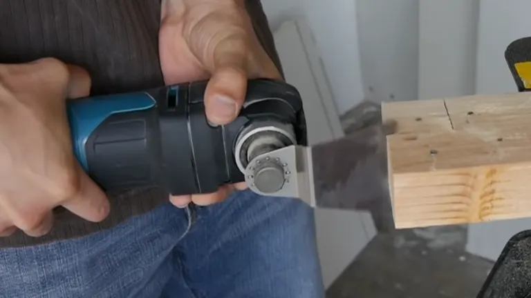 Detailed view of the Makita multi-tool's blade and adjustment settings in a workshop setting.