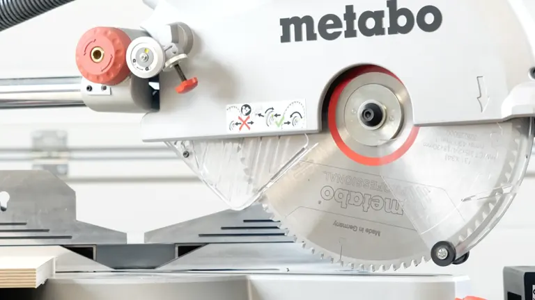 Detailed view of the Metabo KGS 315 Plus saw blade and safety markings during operation.