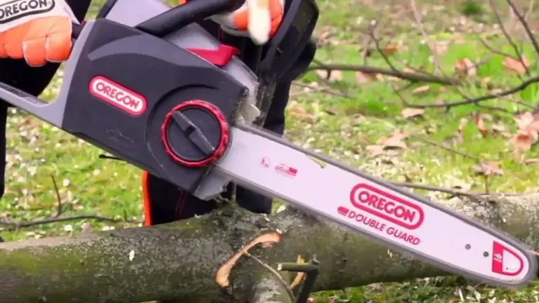 Close-up of an Oregon electric chainsaw cutting through a small branch.