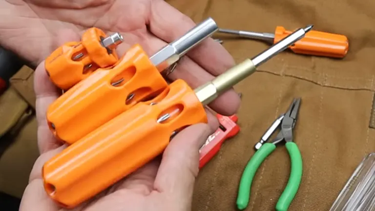 A person lifting three Picquic screwdrivers, with tools positioned underneath them.