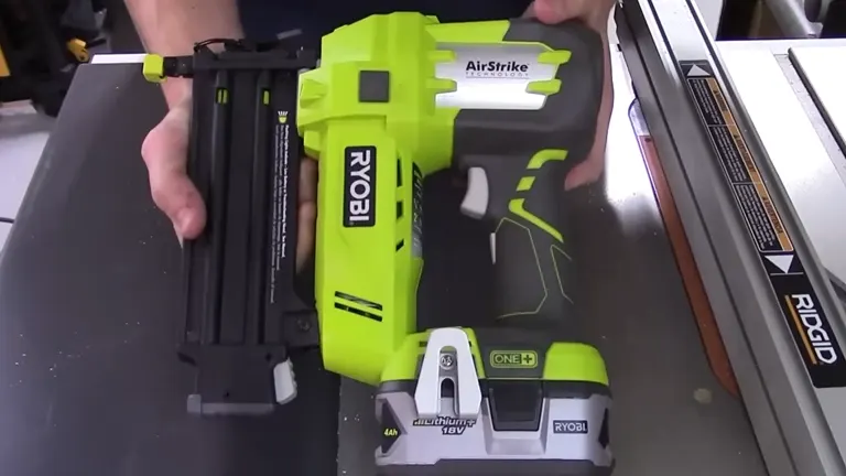 Ryobi P320 Airstrike Brad Nailer displayed on a workbench, showing its long magazine and battery.