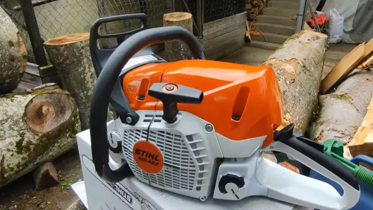 STIHL MS 462 Chainsaw sitting on the box and logs beside it