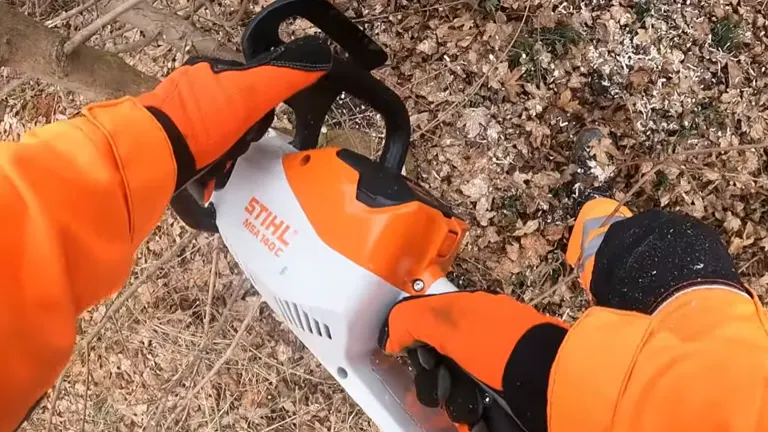 Person with PPE using STIHL MSA 70 C-B Cordless Chainsaw cutting branches