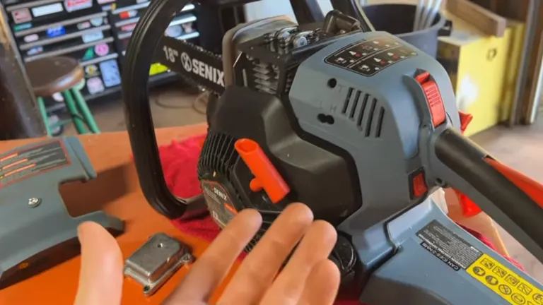 Close-up of a person's hand adjusting a Senix chainsaw with visible valve cover and settings.