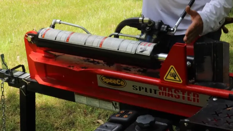 Close-up of the hydraulic cylinder and control valve on a SpeeCo SplitMaster log splitter."