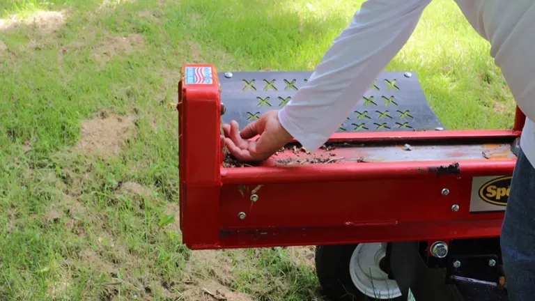 Close-up of a person getting trap wood chips from  SpeeCo log splitter.