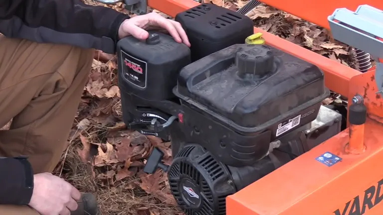 Person touching the engine of the Yardmax 35 Ton Log Splitter
