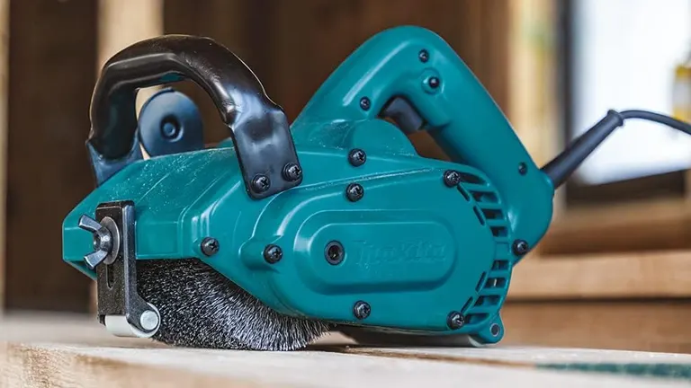 Makita 9741 Wheel Sander on a workbench with visible brush and control features.