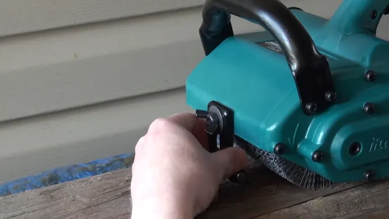 Close-up of a hand adjusting the depth gauge on a Makita 9741 Wheel Sander.