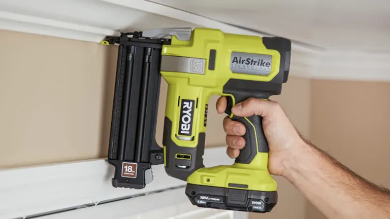 A Ryobi cordless nailer being used to fasten trim to a wall, highlighting its portability and convenience without a compressor.