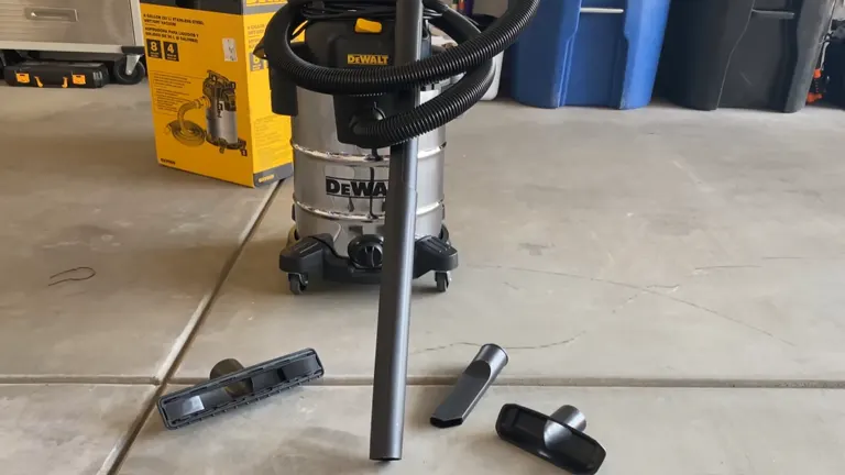 DeWalt vacuum with floor nozzle attachment, demonstrating use on a garage floor.
