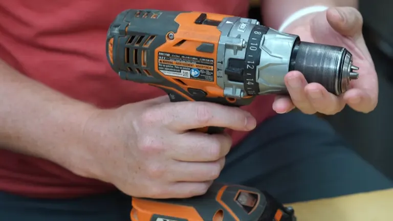 Close-up of an orange cordless drill with a detailed view of the chuck and settings.



