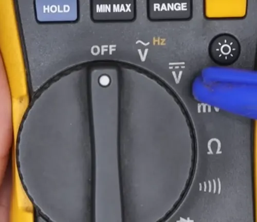 Detailed view of a multimeter's selection knob featuring voltage, resistance, and frequency settings.