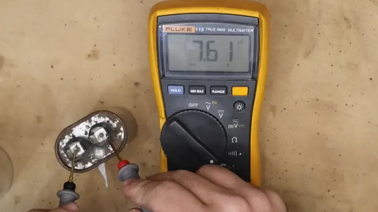 Hands testing a small electronic component with a multimeter, showing a reading of 76.1 on the display.