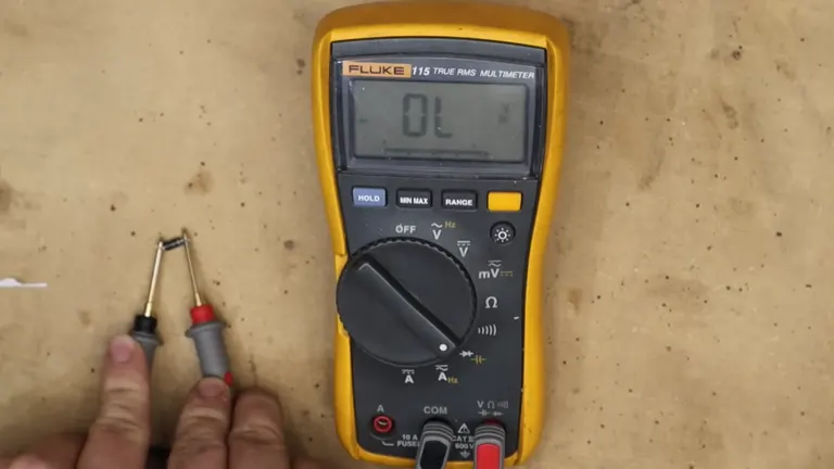 Multimeter in use measuring minimal voltage with probes touching each other, displayed as 0.1 on screen.