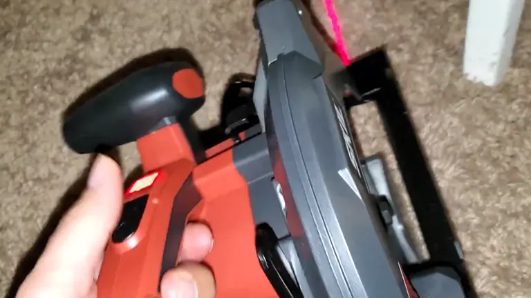 Hand holding SKIL Circular Saw showing red laser guide.