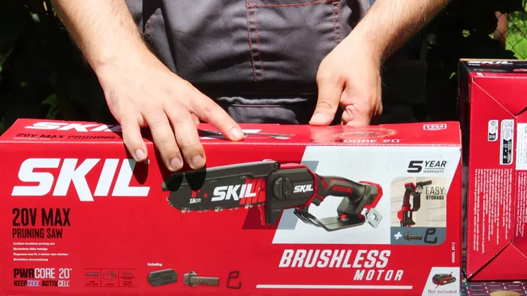 Person unboxing a new Skil Mini Chainsaw next to the product box.
