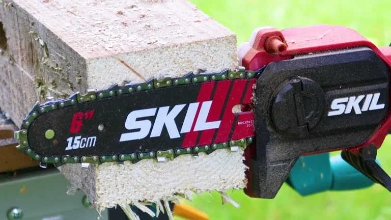 Close-up of a Skil Mini Chainsaw cutting into a pale block of wood on a green stand.
