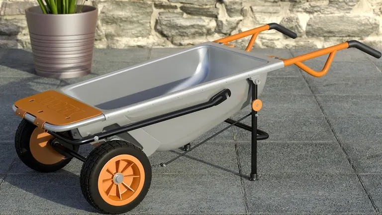 Silver WORX Aerocart with orange handles and legs, displayed on a stone patio.