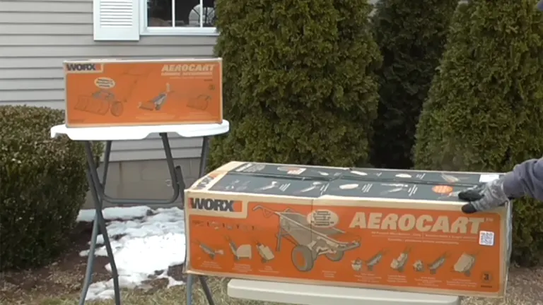 WORX Aerocart packaging displayed on a table outside with evergreen trees in the background.