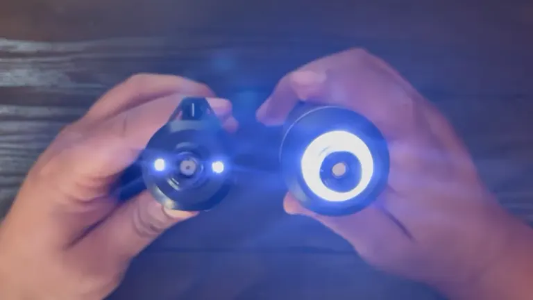 Hands holding two parts of a gadget with glowing blue lights, possibly part of a WORX tool feature.