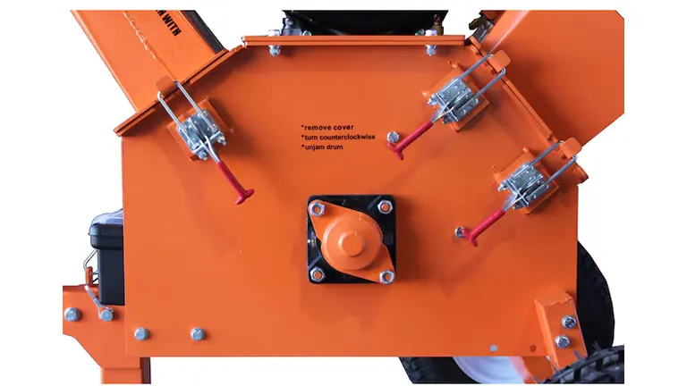 Top view of the POWER KING wood chipper showing operational labels for maintenance and safety on an orange surface, detailing cover removal and drum access.