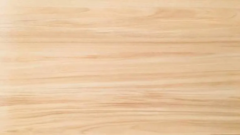 Close-up of light-colored wood grain with subtle wavy lines