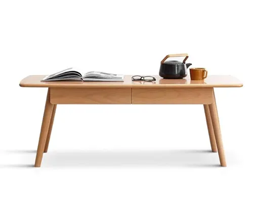 Modern light wood coffee table with round edges, holding a book, glasses, a teapot, and a cup.