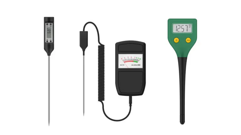 Assortment of soil testing tools including pH meters and a temperature probe laid out for display.