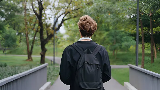 Student with a backpack walking through campus, choosing the right program.