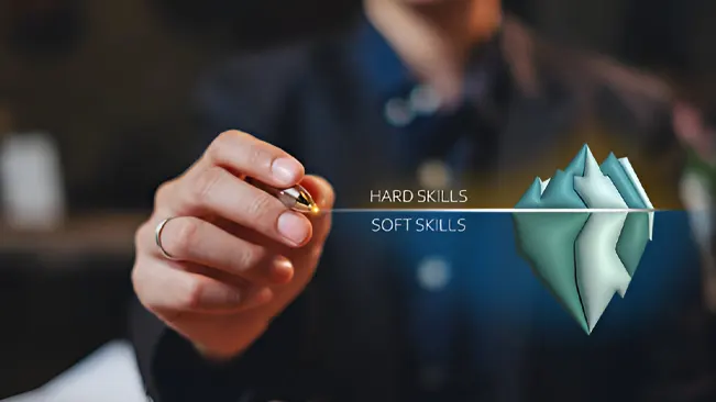 A person illustrates the concept of hard skills vs. soft skills using an iceberg metaphor, where hard skills are above water and soft skills are below.