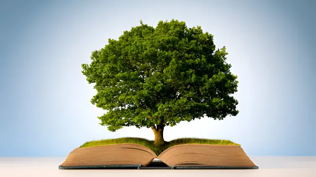 An open book with a tree growing from it, symbolizing educational resources for foresters