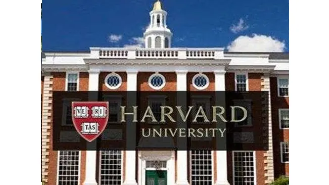 Harvard University logo in front of a classic brick building.