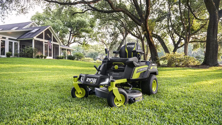 Ryobi 80V HP Brushless 42" Lithium Electric Zero Turn Riding Mower parked on a neatly trimmed lawn in front of a house.
