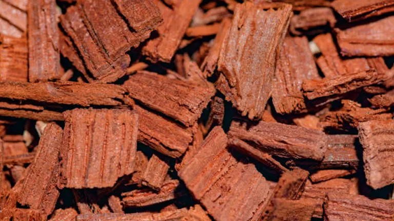 Close-up of reddish-brown wood chips used for fragrance or incense.