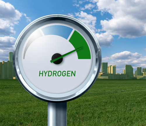 A gauge indicating hydrogen levels set in a green field, with a modern city skyline and blue sky with clouds in the background.